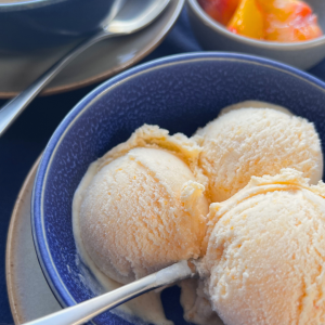 Orange peach butter ice cream in a blue bowl